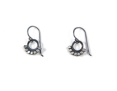 silver dot earrings around a circle in the middle, by Alice Scott, on a white background