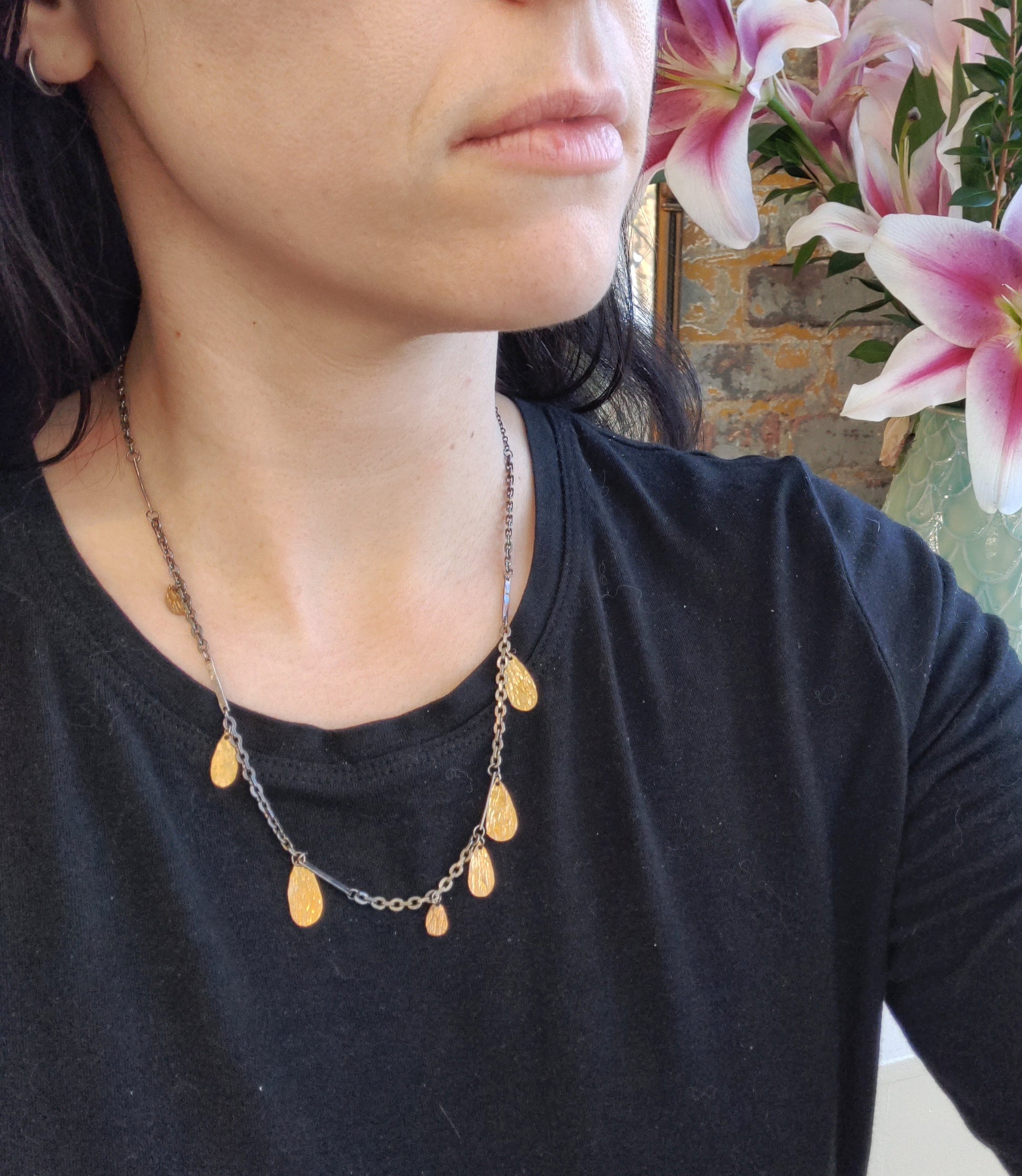 gold fill hammered drops on blackened silver chain on model neck, by Alice Scott