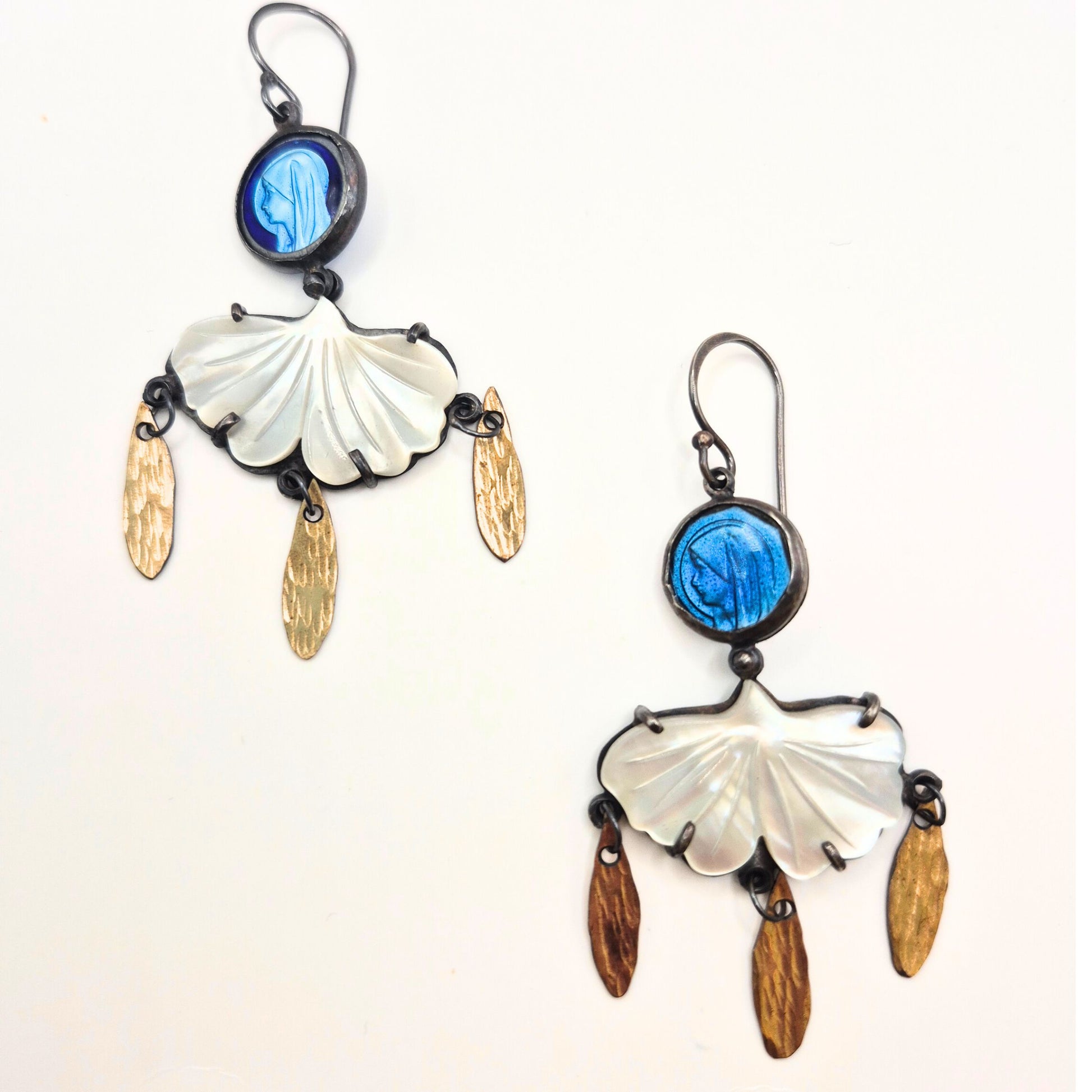 Pair of earrings with shell and vintage rosaries on a white background by Alice Scott