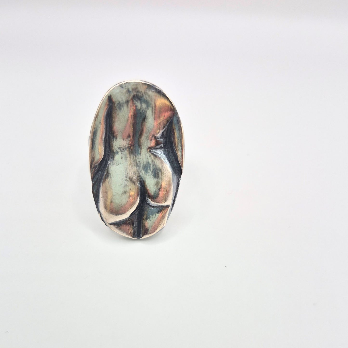 Oval-shaped lady butt ring on a white background by Alice Scott
