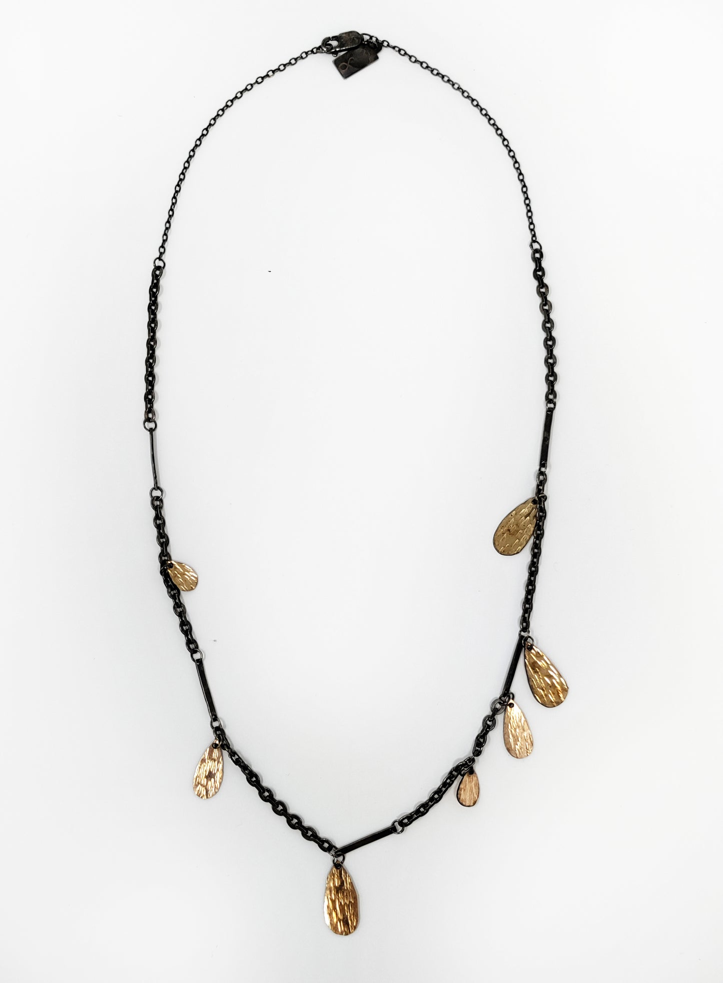gold fill hammered drops on blackened silver chain with white background by Alice Scott