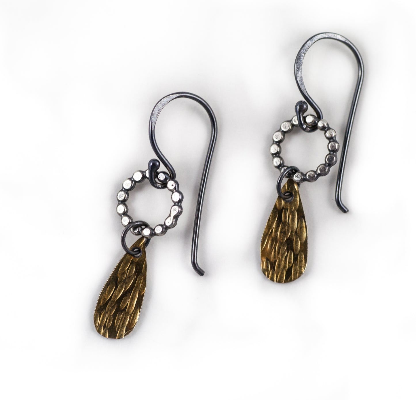 A pair of handmade dangle earrings with gold drops and sterling silver components, displayed on a white surface, by Alice Scott