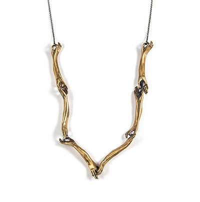 A necklace with bronze hand-shaped links connected by silver rings, with a blackened silver chain by Alice Scott on white background